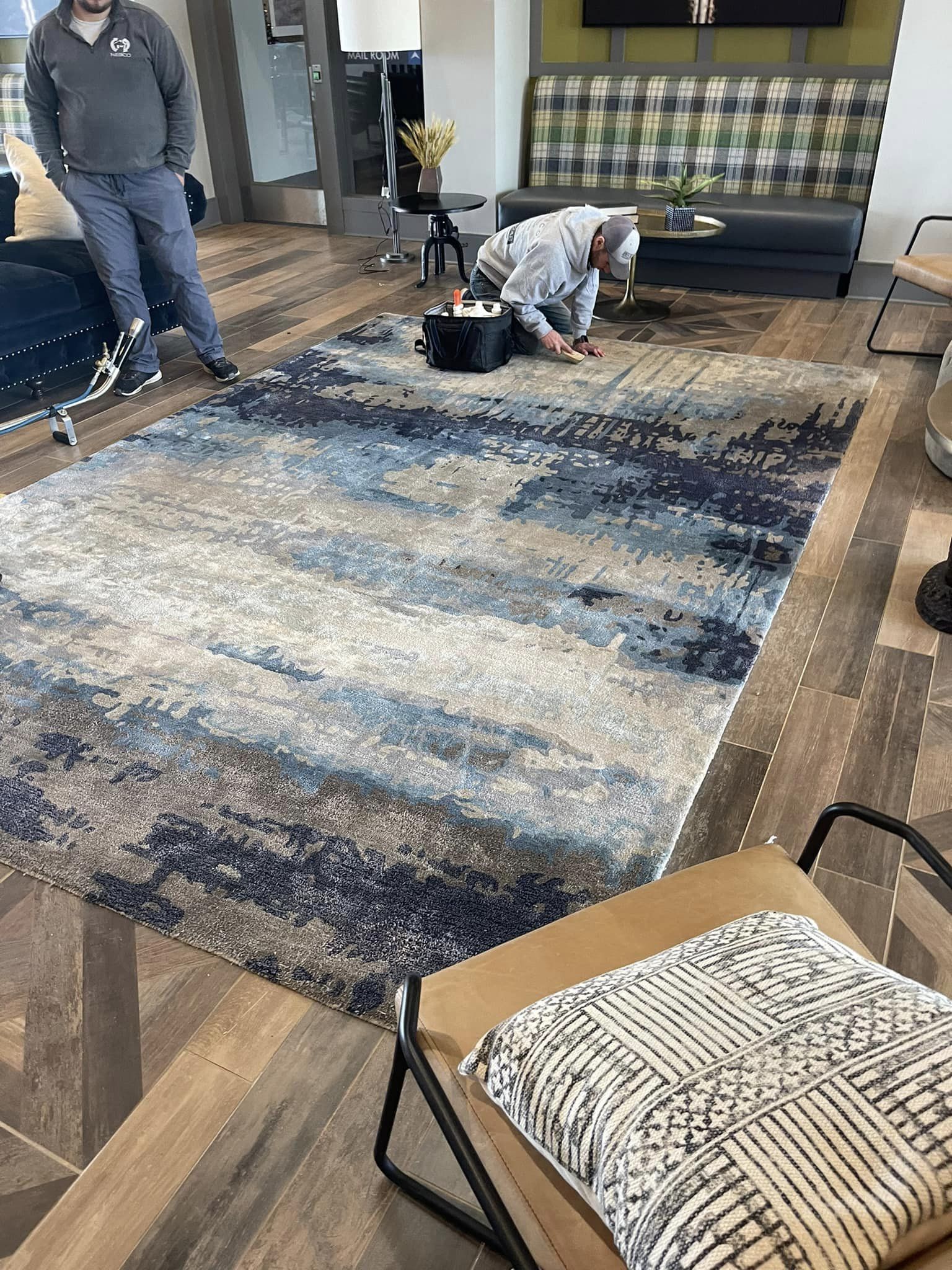 A person cleaning a rug